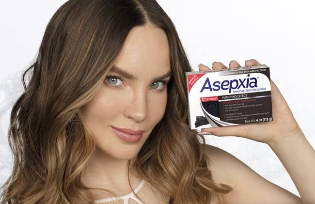 Person holding Asepxia soap container with