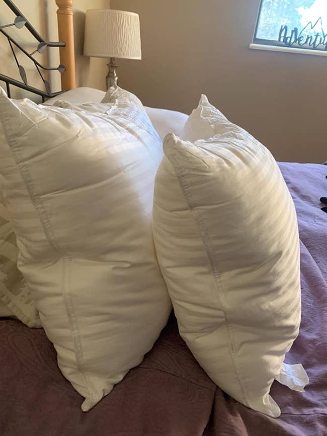 reviewer image of two down alternative pillows from the side