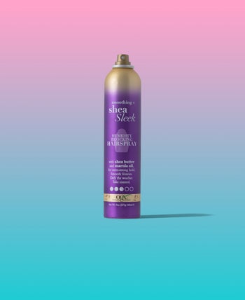 a purple and uncapped bottle of hairspray against a pink and blue background