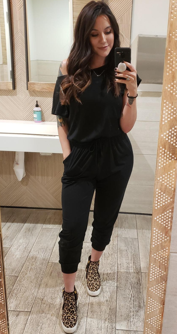 reviewer wearing the black jumpsuit