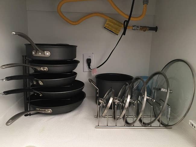 a reviewer's stacked frying pans and lids organized successful  a room  furniture  with a cookware  rack and lid holder