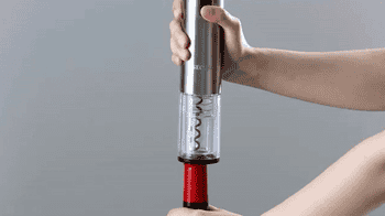 gif of model using the electric wine opener to open a bottle of wine