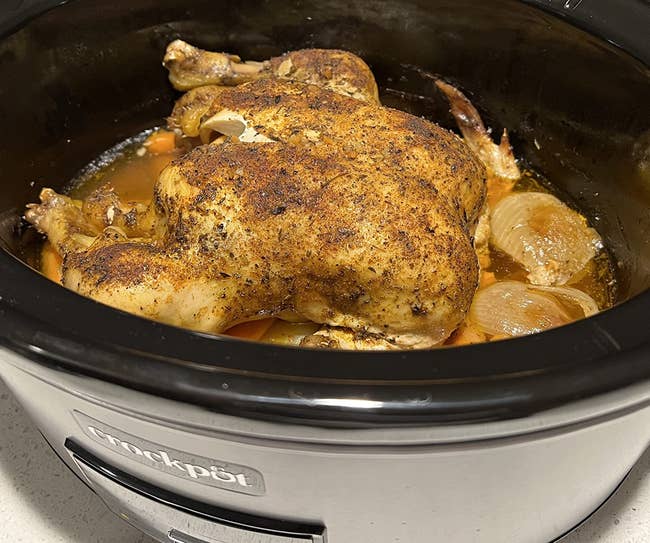 A reviewer's entire chicken fitting inside the crockpot with extra room around it