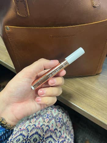 Person holding a conduit  of articulator  plumper successful  beforehand   of a brownish  leather bag, suggesting a quality   merchandise  reappraisal  oregon  recommendation