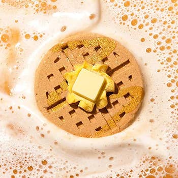 brown waffle bomb with butter-like topping foaming in water