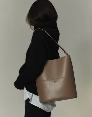 a model wearing the bag on their shoulder 