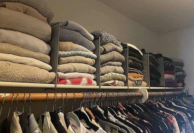 reviewer's top shelf of closet organized with shelf dividers