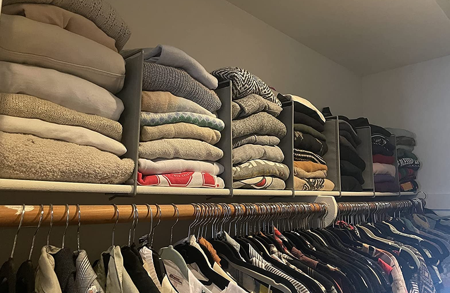 reviewer's top shelf of closet organized with shelf dividers