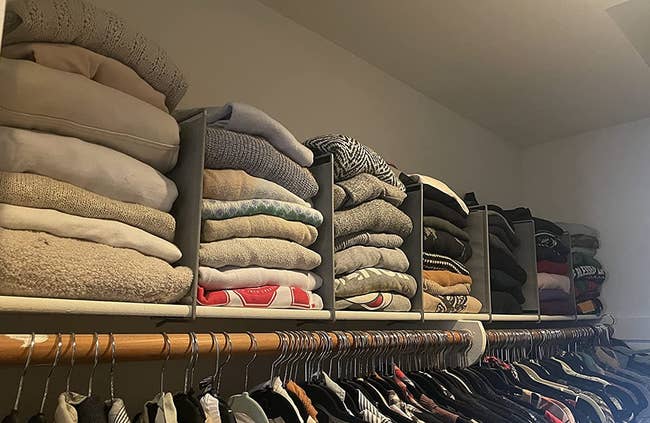 reviewer's top shelf of closet organized with shelf dividers