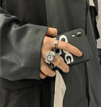 model wearing the silver watch ring on their finger