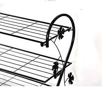 Metal footwear  rack with decorative floral accents connected  the sides, featuring 2  ligament  shelves for storing footwear