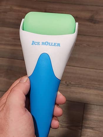 The reviewer holding the ice roller in their hand
