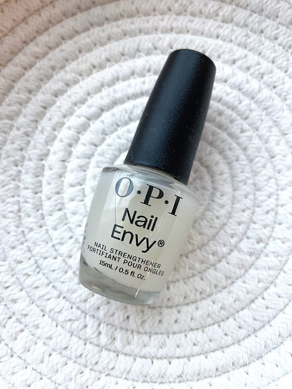 OPI Nail Envy nail strengthener bottle on a textured surface