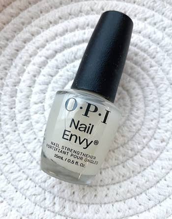 OPI Nail Envy nail strengthener bottle on a textured surface