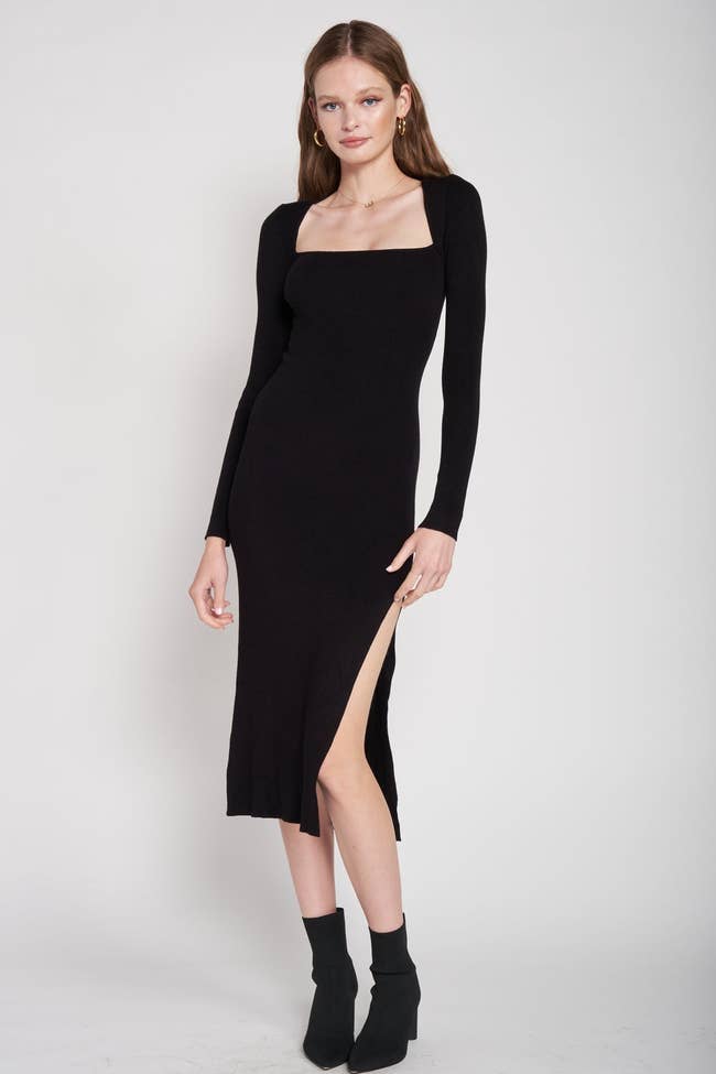 model wearing square neck midi dress in black with slit up the side