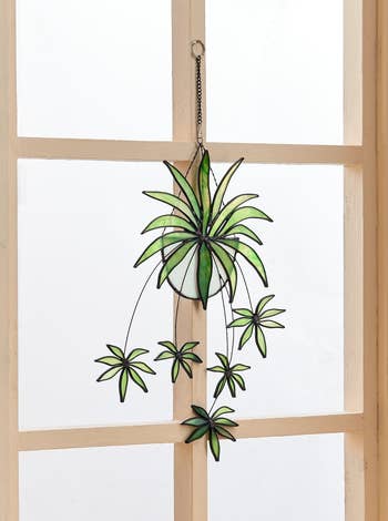 Stained glass greenery decor hanging in a window for a fresh home accent