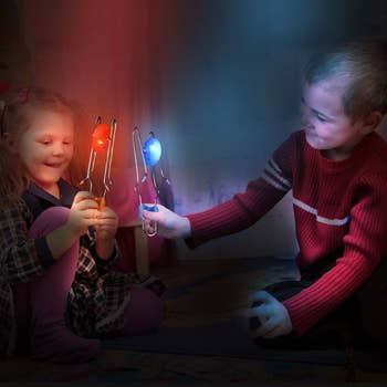 two children playing with the red and blue light-up gyro wheels