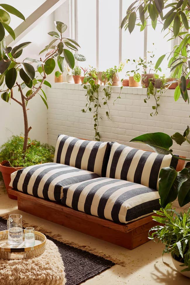 striped plush outdoor sofa with wood details