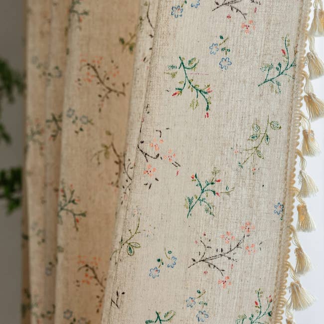 floral curtains with tassels along the edge