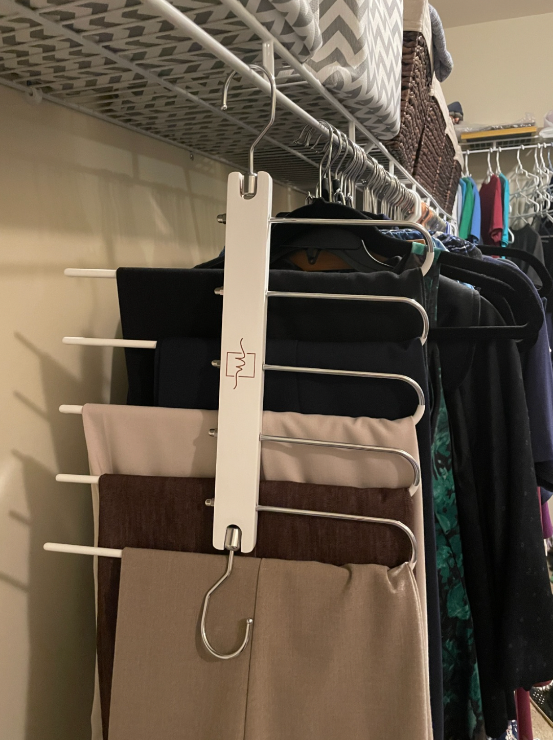 a reviewer using the hanger for their pants