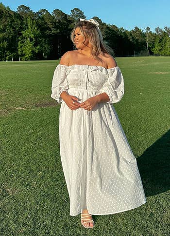 a reviewer in whitte with the sleeves off shoulder