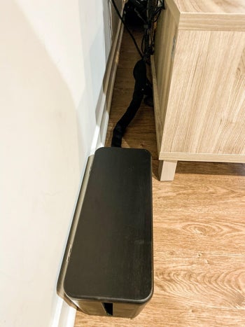 reviewer after image of all the cables neatly stored in the cable management box