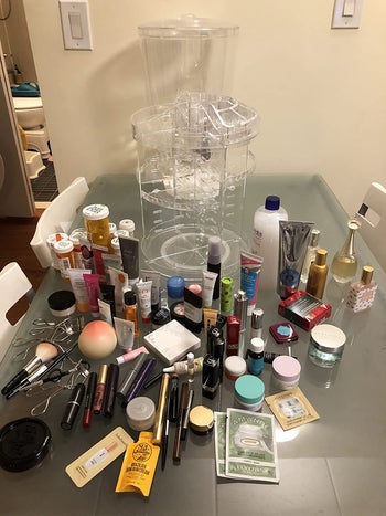 reviewer's skincare and makeup spread out on a table