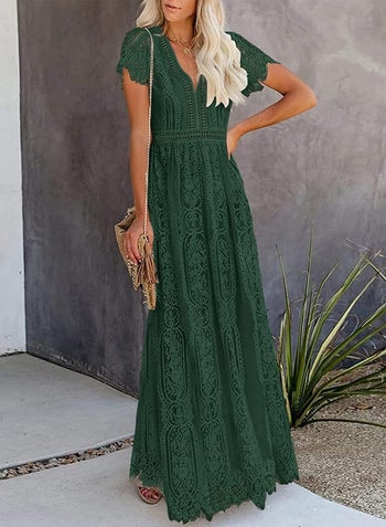 a model in a dark green lace maxi dress