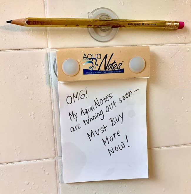 AquaNotes attached to the wet shower wall with note