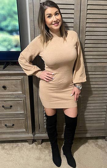 reviewer wearing the beige dress with black boots