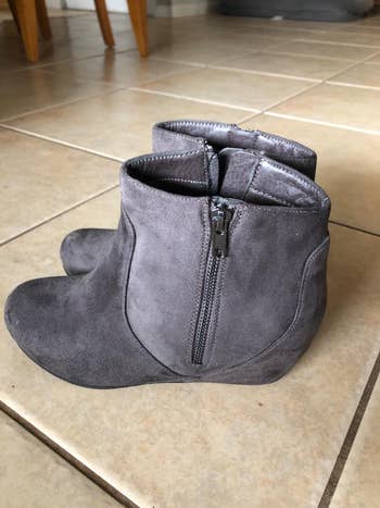 reviewer photo of a pair of gray suede wedge boots