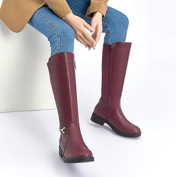 model wearing the burgundy boots