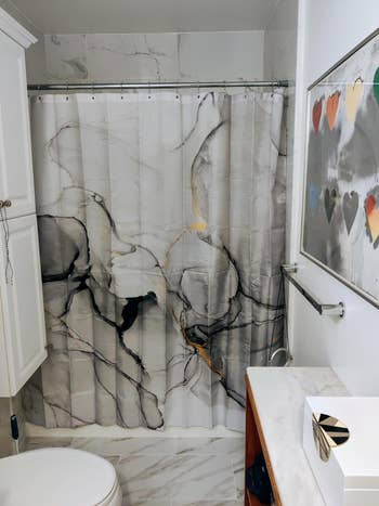 reviewer's marble-patterned shower curtain 