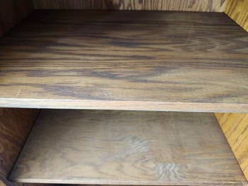 Two bare  woody  shelves wrong  a cabinet, showing a elemental  retention  solution