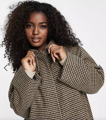 Model wearing checkered coat, closer up