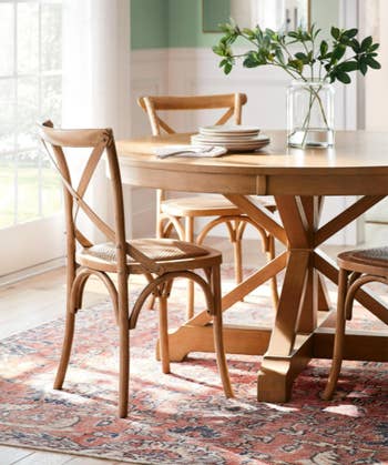 Image of the brown table with chairs and a plant on it