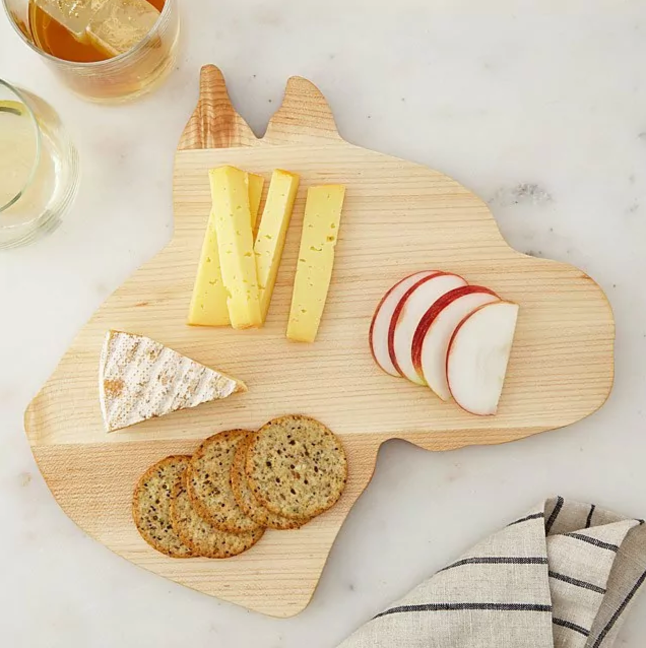Dog-shaped cheese board with food sprawled on it