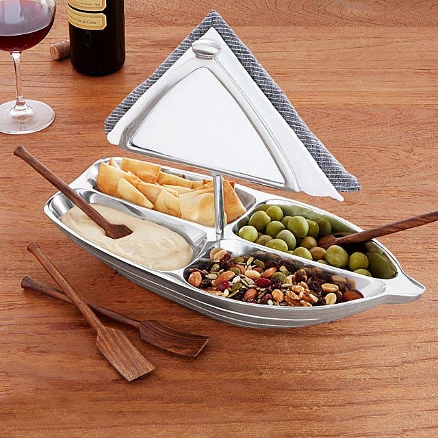 rowboat serving bowl with snacks inside, napkin inside napkin holder