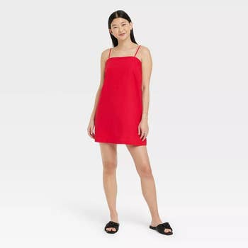 a straight sized model wearing the red dress