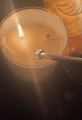 gif of reviewer using the electric lighter on a candle