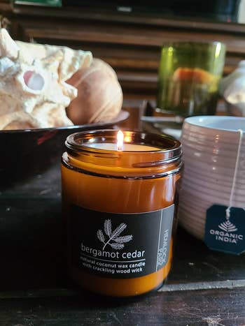 reviewer photo of their lit bergamot-scented candle