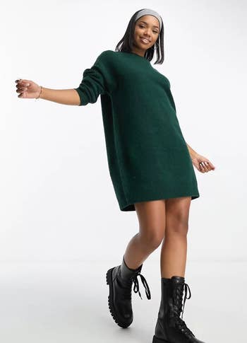 model wearing the dark green sweater dress
