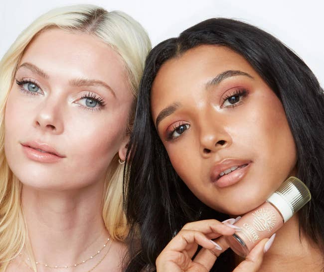 Two models airs  with radiant makeup; 1  holds a tiny  vessel  of quality   product, suggesting a skincare oregon  cosmetic point  for a buying  article