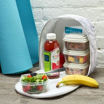 a prepared lunch inside the lunch bag with food filling each container and room for a bottled drink