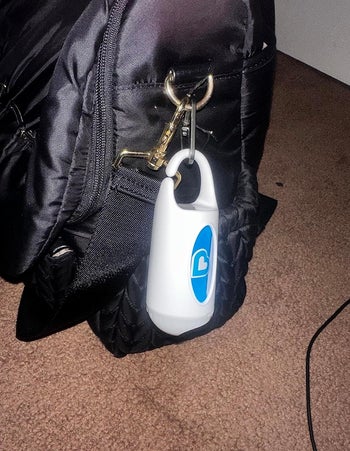 The dispenser clipped on to a reviewer's diaper bag