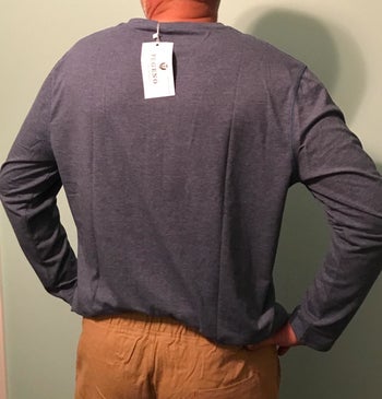 back of same reviewer wearing the long-sleeve henley in blue 