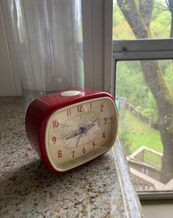 red version of the clock on a counter 