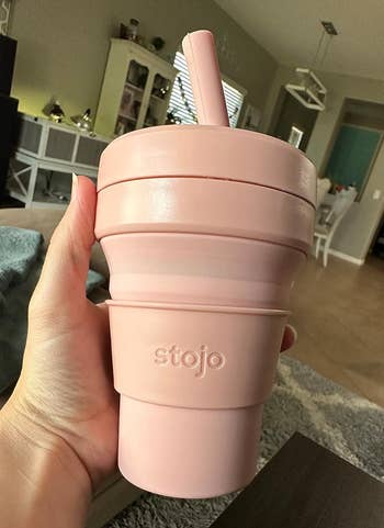 reviewer holding pink tumbler