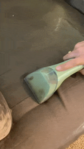 gif of someone using the cleaner to clean their couch cushion