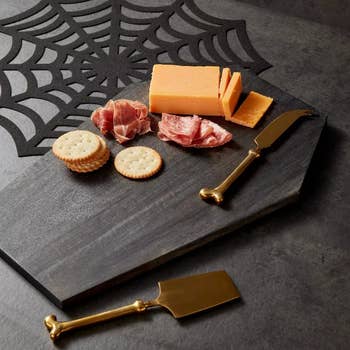 a black charcuterie board in the shape of a coffin